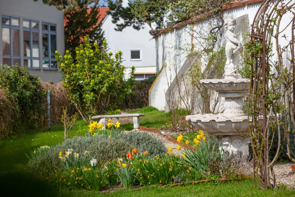 Begrünter Innenhofgarten mit Brunnen am Rosenschloss
